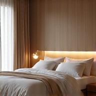 Luxurious, minimalist bedroom designed for optimal sleep with dim lighting and natural textures, illustrating sleep habits.